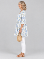 Cornelia long blouse in white with cornflower blue wildflower print, side view showing the relaxed fit