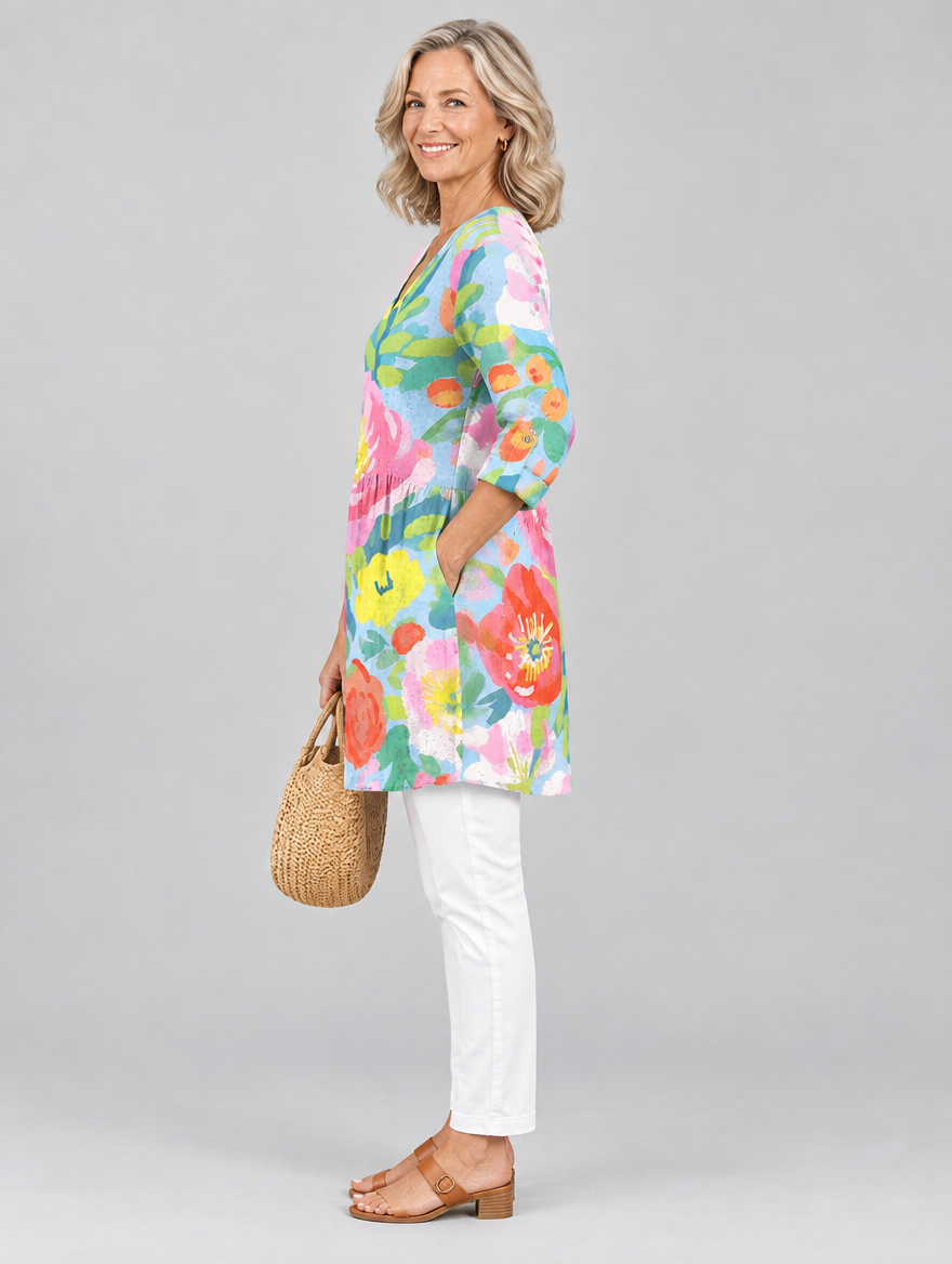 Florinda long blouse in pastel watercolour poppy print on sky blue, side view showing the relaxed fit
