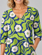 Joni long blouse in navy and lime retro daisy print, close up of print and neckline