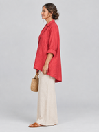 Rubina relaxed tunic in coral red, side view showing the relaxed fit