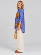 Brynja relaxed tunic in periwinkle blue sausage dog print, side view showing the relaxed fit
