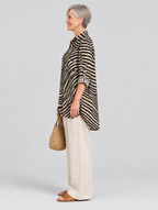 Desma relaxed tunic in sand and black swirl print, side view showing the relaxed fit