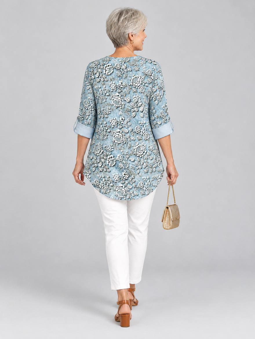 Isaura printed tunic top in light blue with embossed rose print, back view