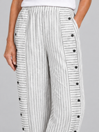 Nanette button trousers in white stripe, close up of waistband, side buttons and fabric