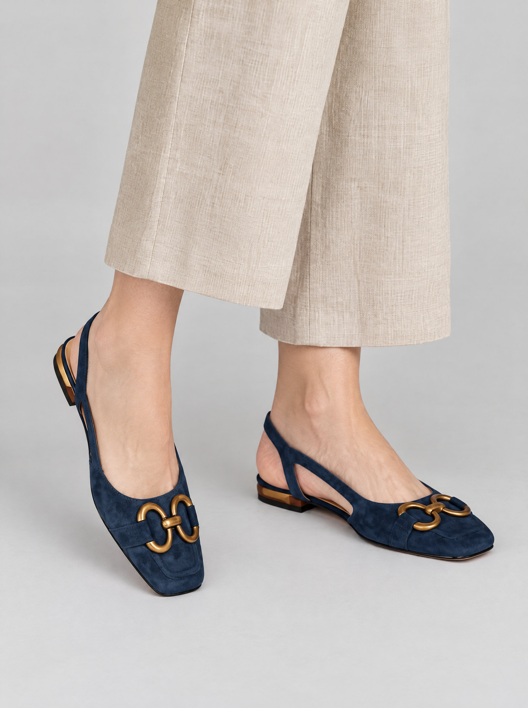 Enya sandals in dark blue, worn with beige linen trousers