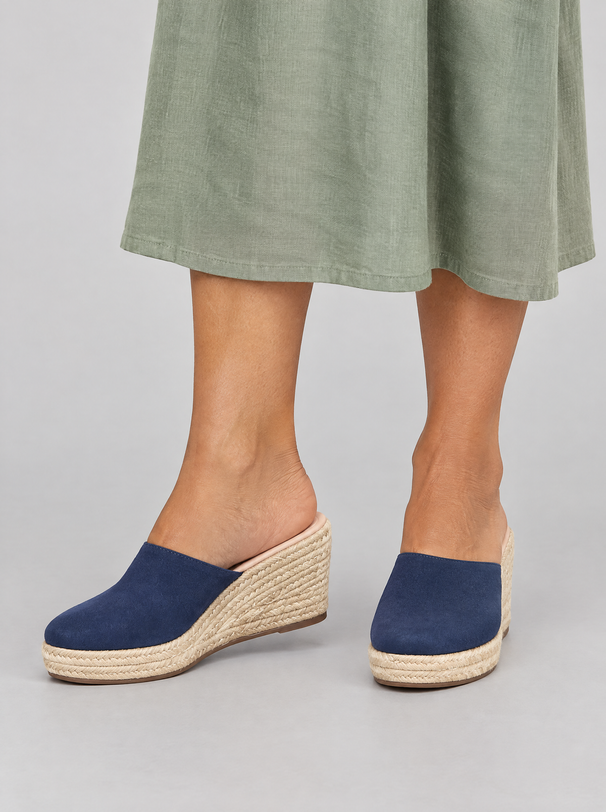 Kirsi sandals in blue, worn with a sage green linen dress