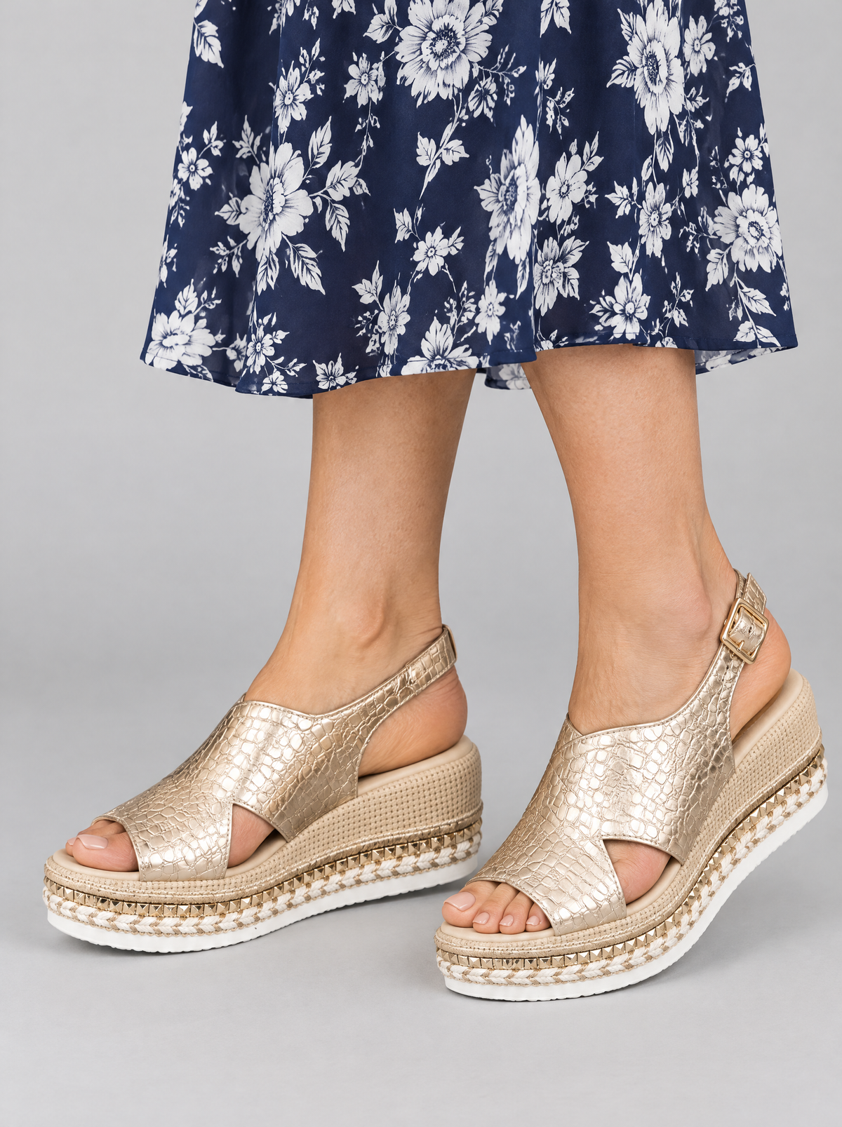 Tove sandals in gold, worn with a navy and white floral dress