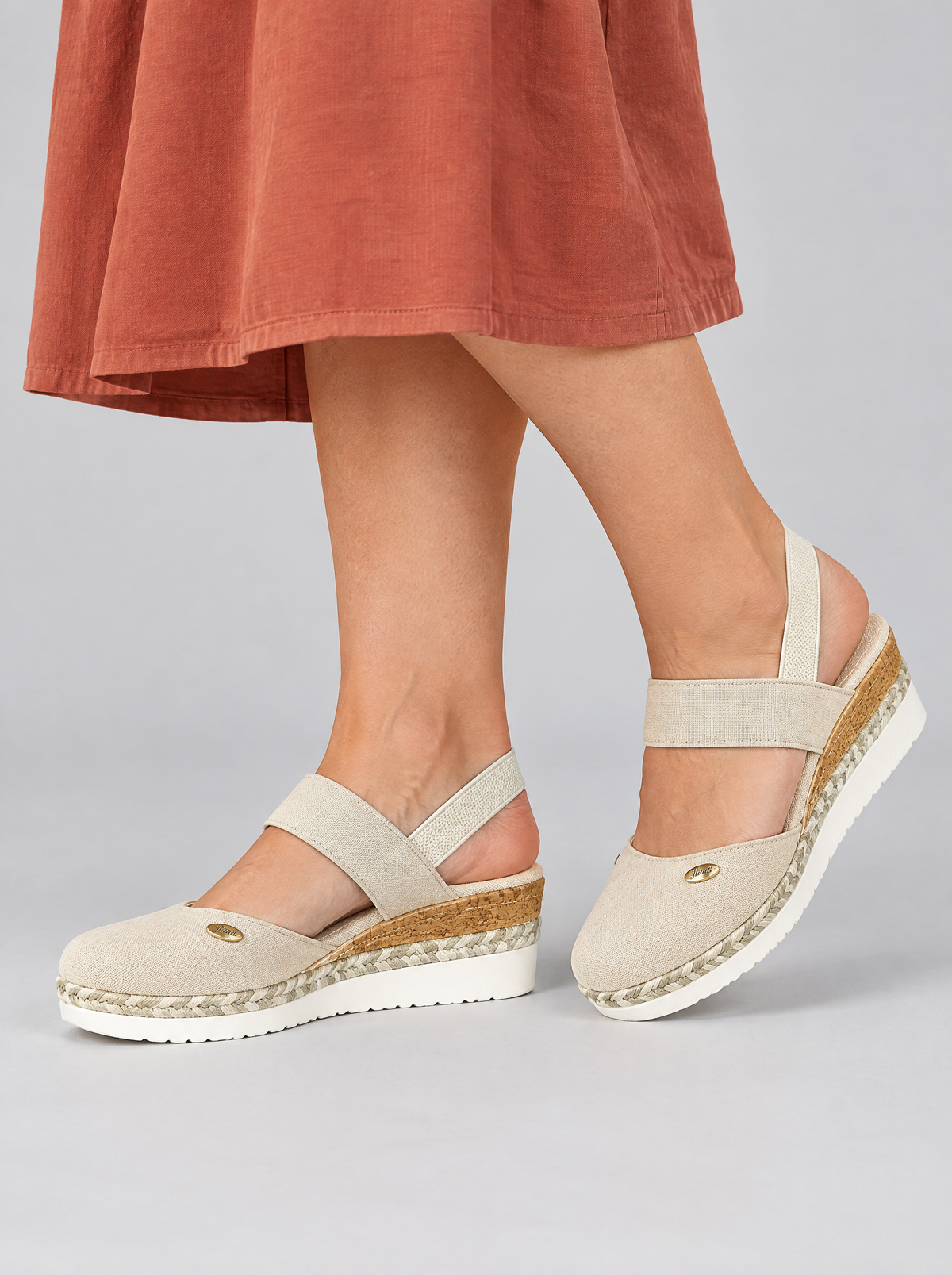 Margit sandals in white, worn with a terracotta cotton dress