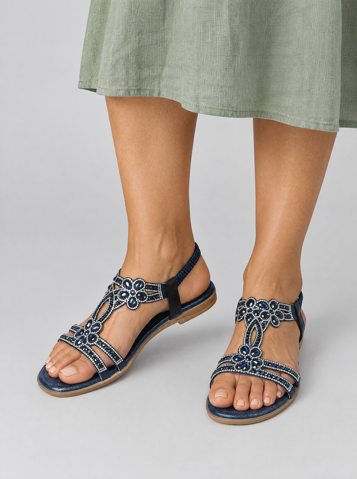 Rosamond sandals in blue, worn with a soft sage green linen midi dress
