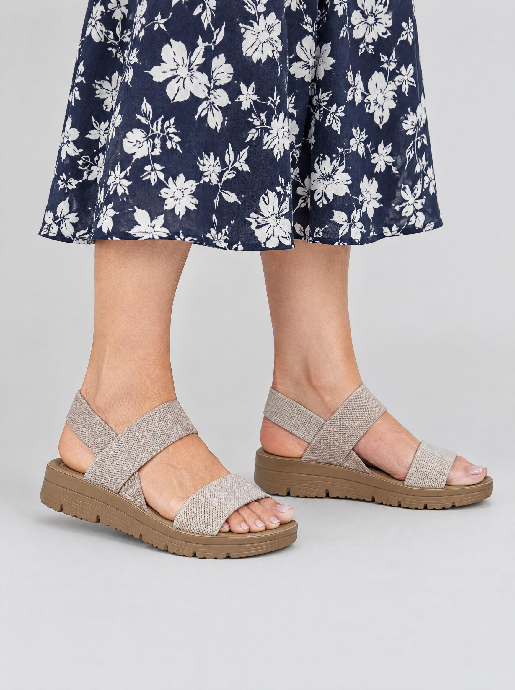 Merle sandals in khaki, worn with a navy and white floral print midi dress