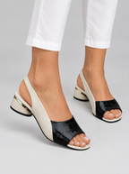 Fleurette sandals in black, worn with slim white cropped trousers