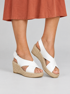 Orabelle sandals in white, worn with a terracotta cotton midi dress