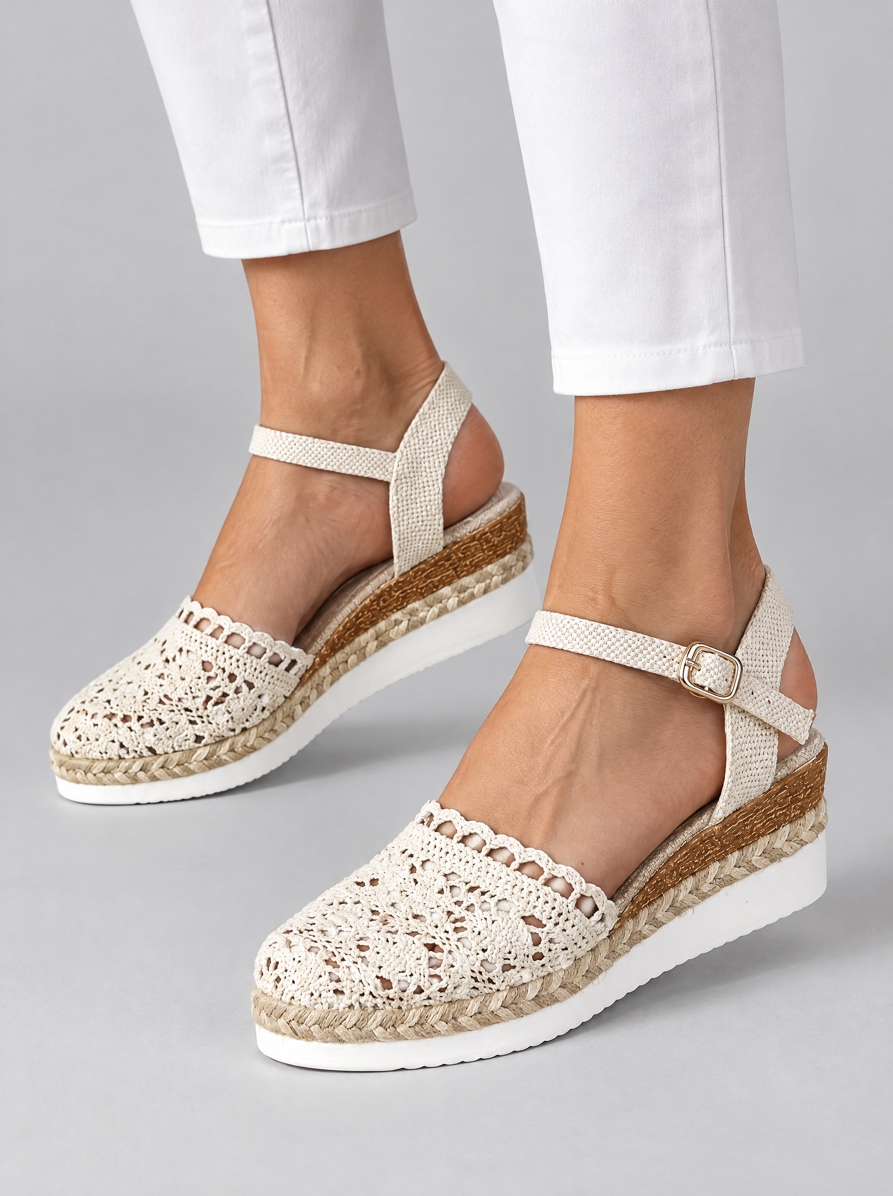Mia sandals in beige, worn with white cropped trousers