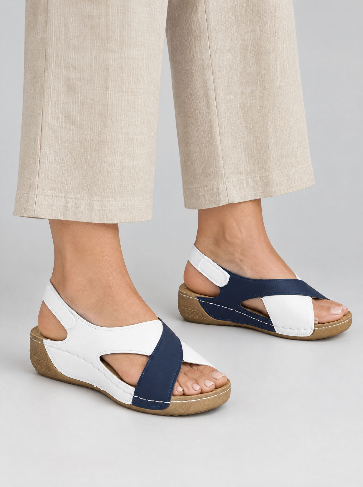 Rosemary sandals in blue, worn with neat beige linen wide leg trousers