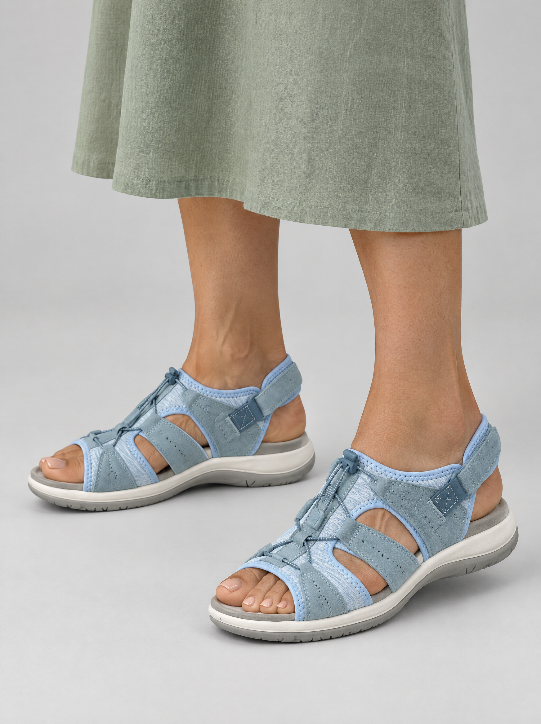 Ursula sandals in blue, worn with a soft sage green linen midi dress