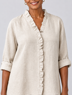 Ravenna ruffled linen blouse in beige, close up of ruffle neckline and sleeve